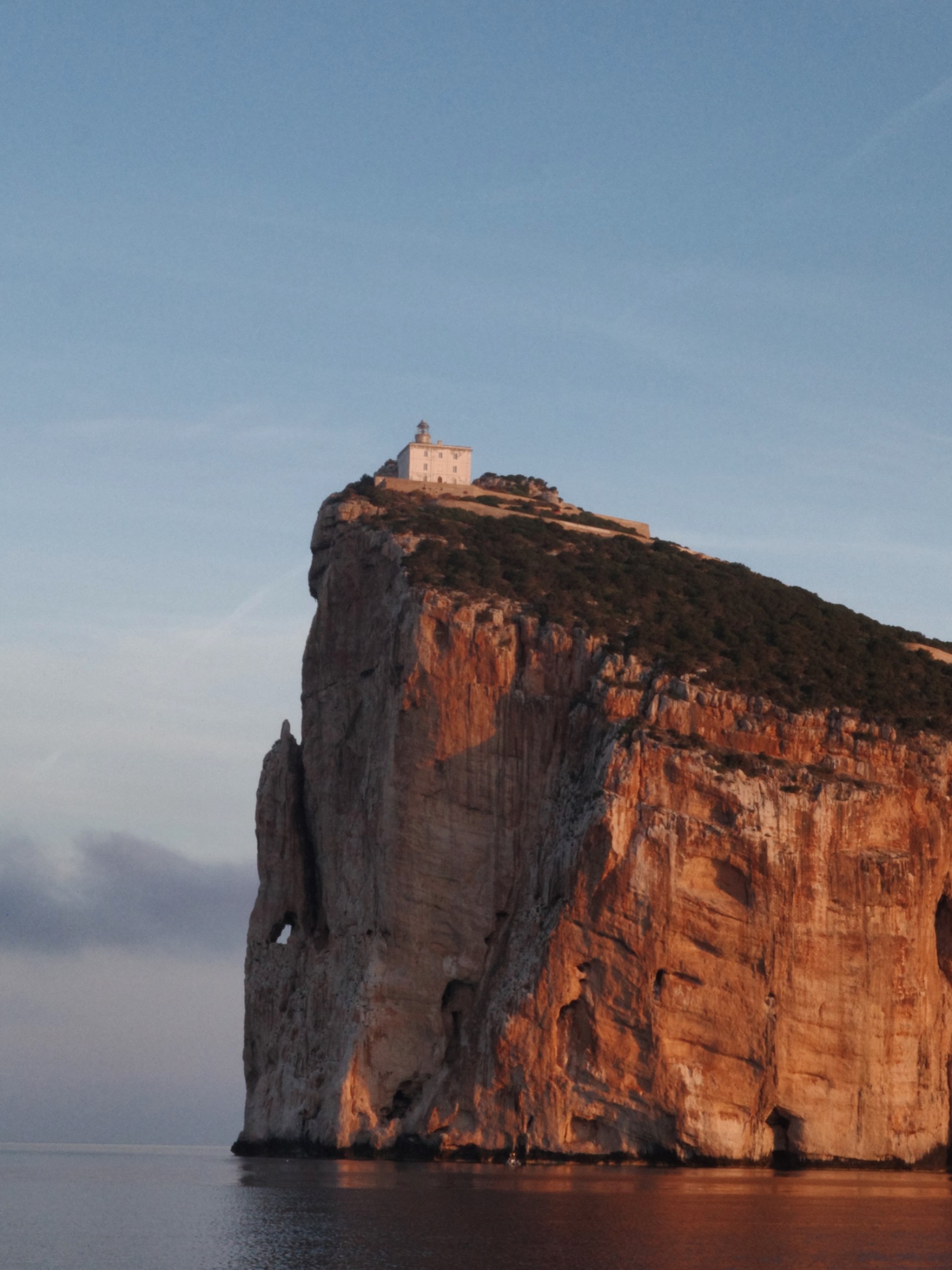A lighthouse above the cliffs on the Sardinian coast